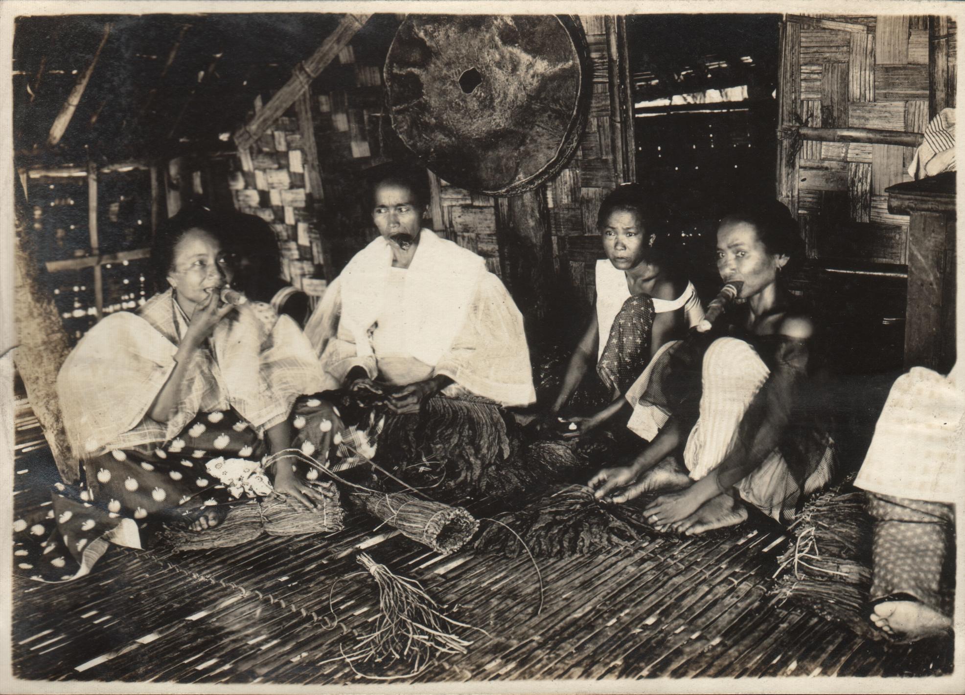 Native tobacco growers. Native women tying up bundles of tobacco [?].