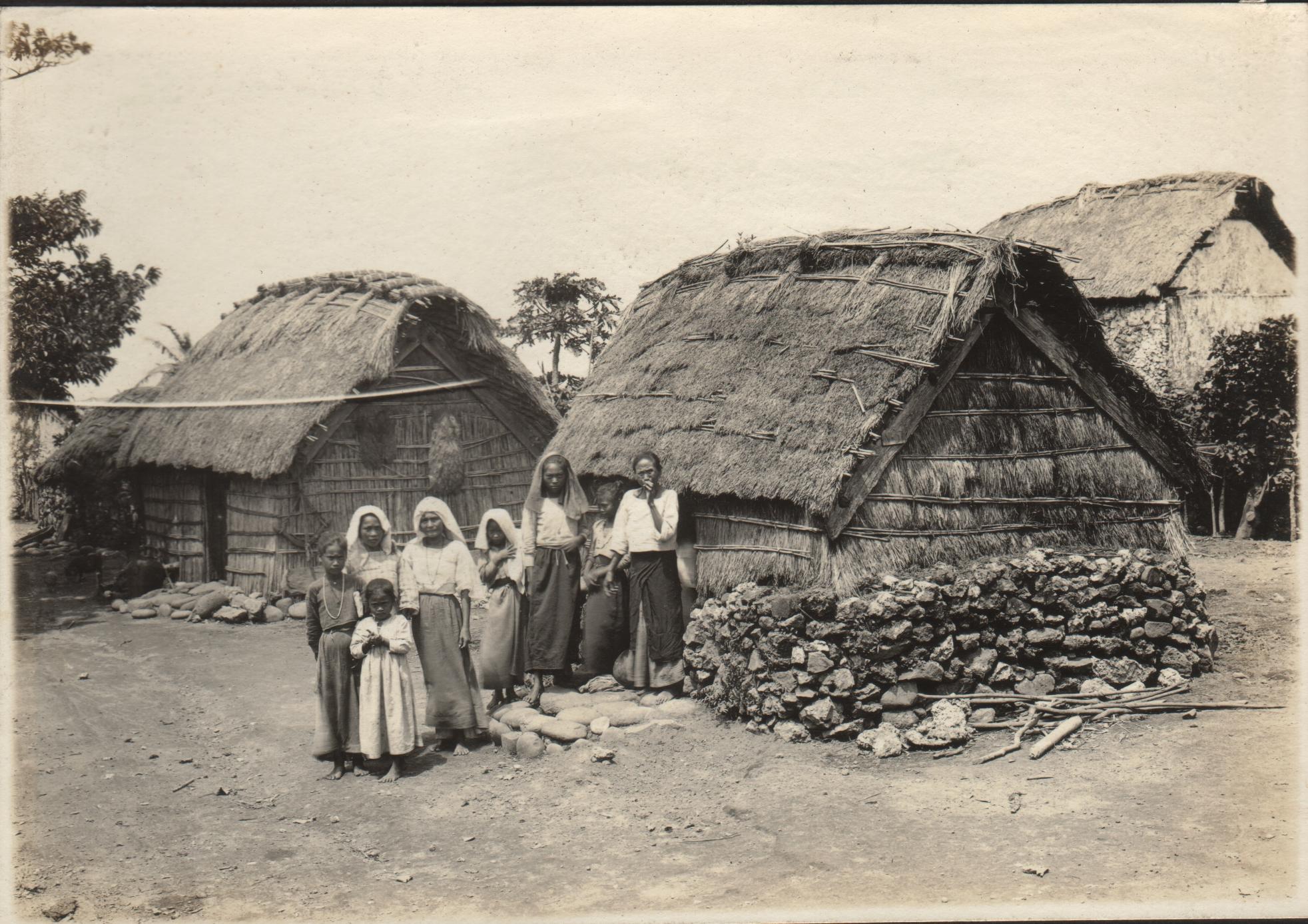 Group of native women and cogon grass houses. Santo Domingo de Basco, Batanes Islands.