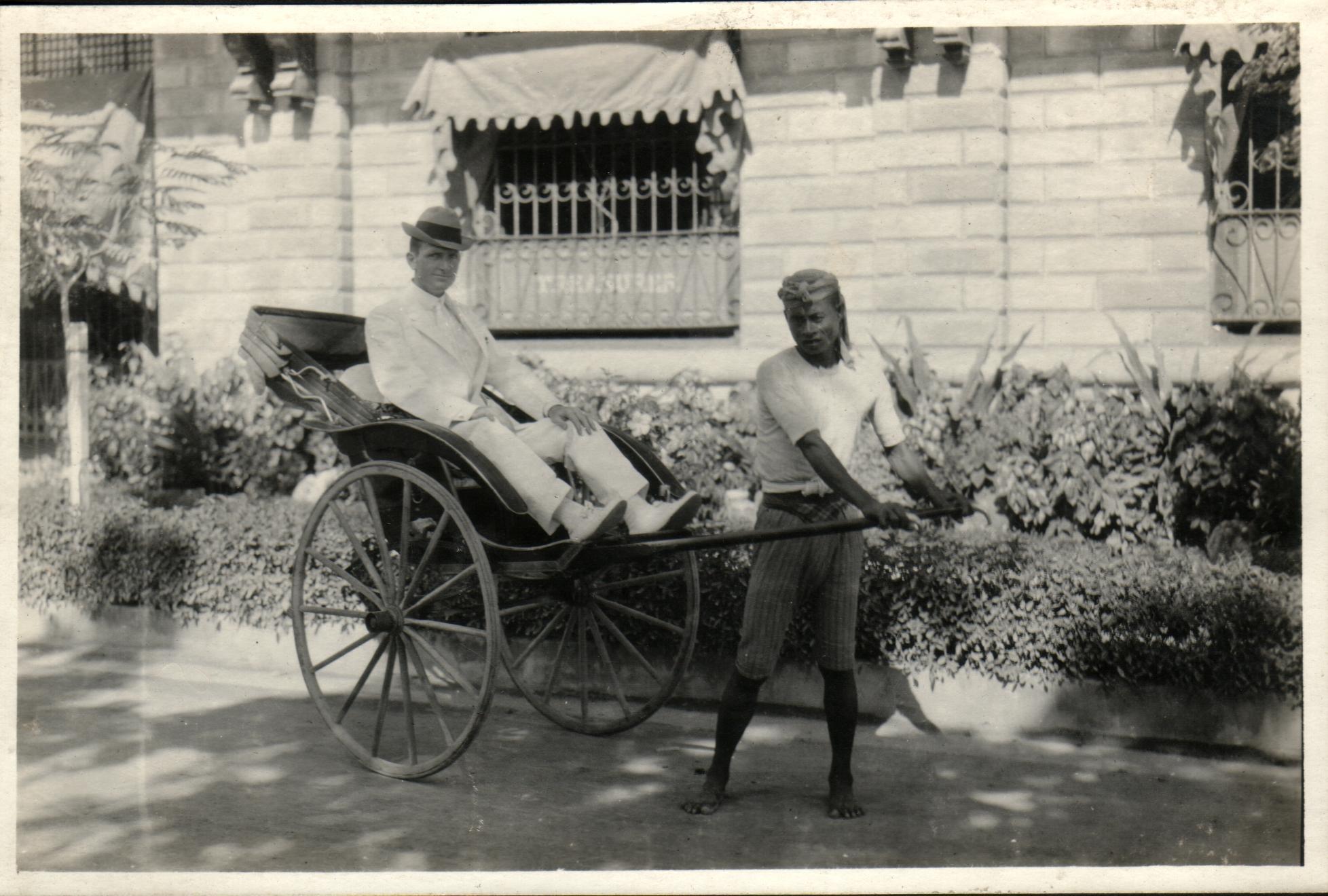 [Untitled – Caucasian man in rickshaw pulled by a Muslim man].