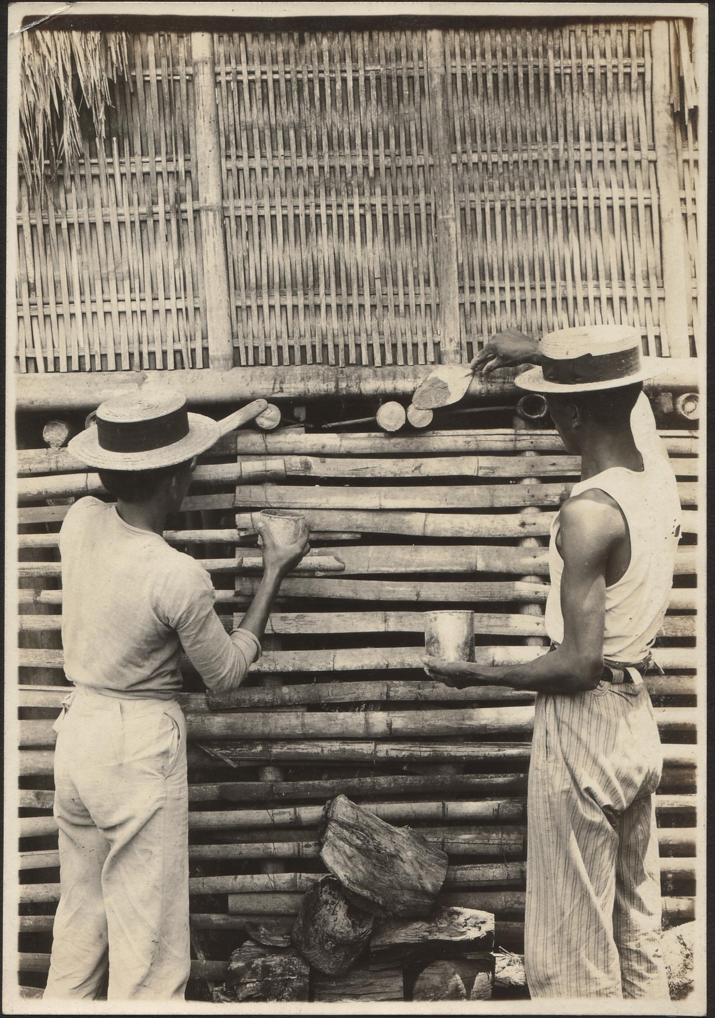 Views showing men cementing holes in bamboo, Manila.