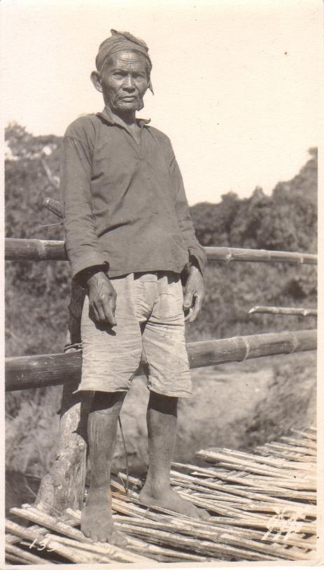 139. [Untitled – Filipino man on a bamboo footbridge].