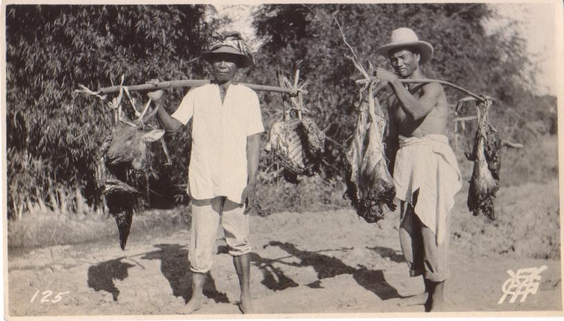 125. [Men carrying cut-up deer carcass].