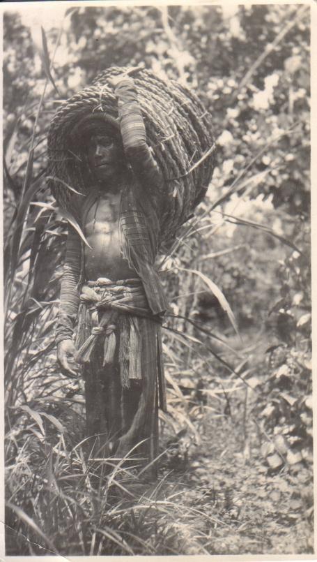 [Untitled – Igorot man carrying an enormous coil of rope on his back].