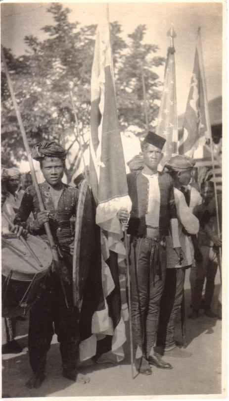 [Untitled – Igorot men, flags, and drums].