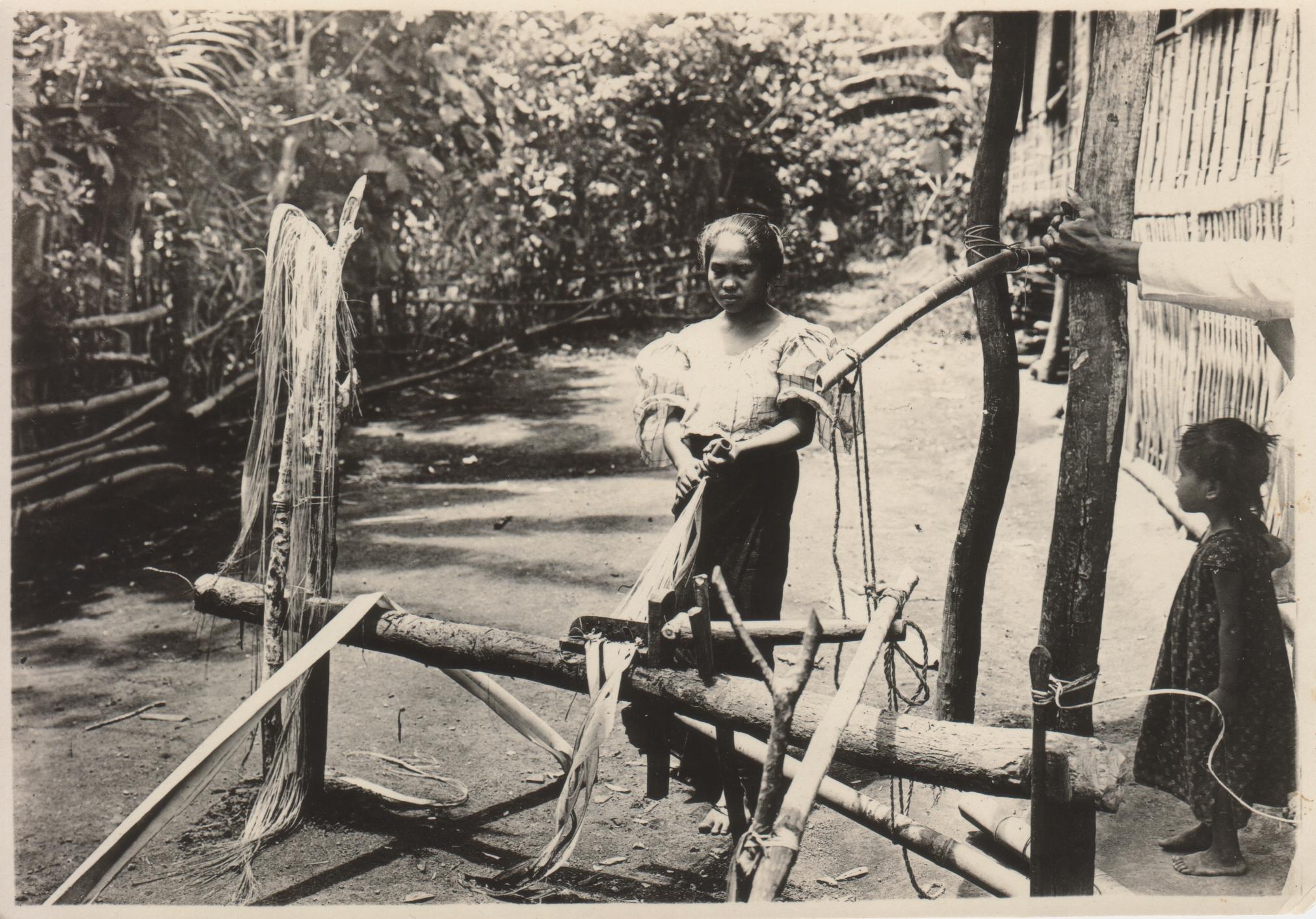 A Bicol girl stripping hemp, Albay Province, P. I.