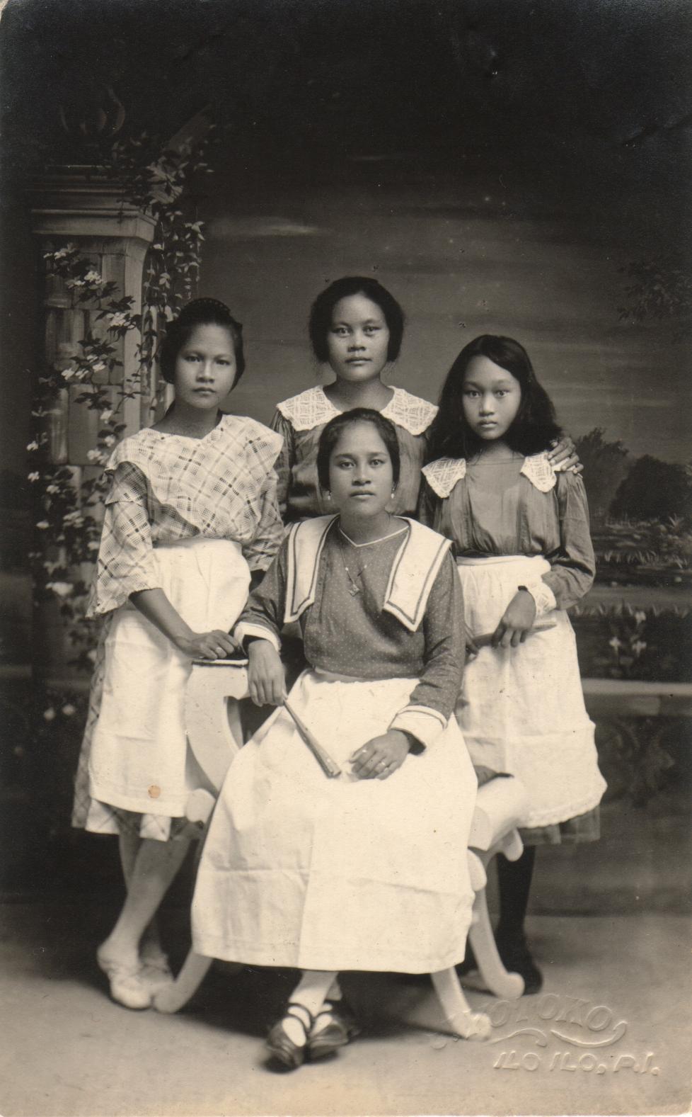 [Untitled – Studio portrait of four young Filipino women].