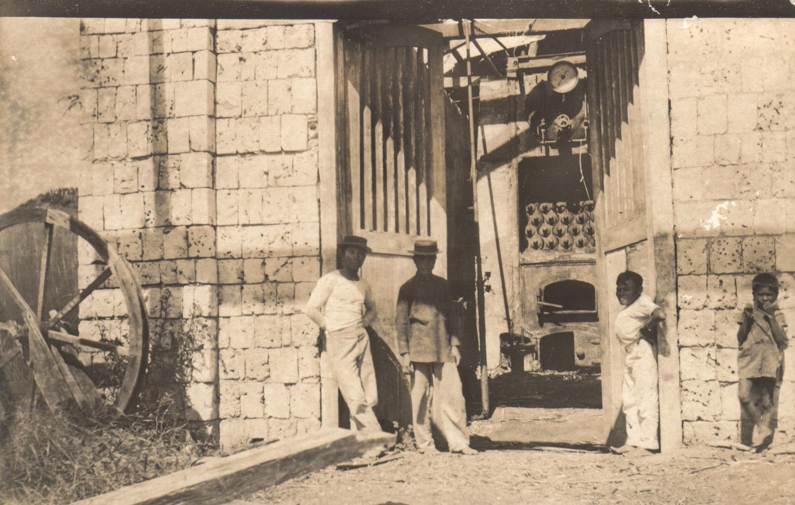 Capiz [Men standing by a factory].