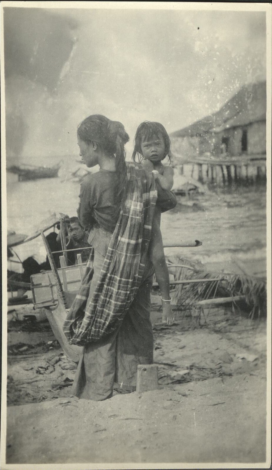 [Untitled – Filipina holding her daughter at the seashore].