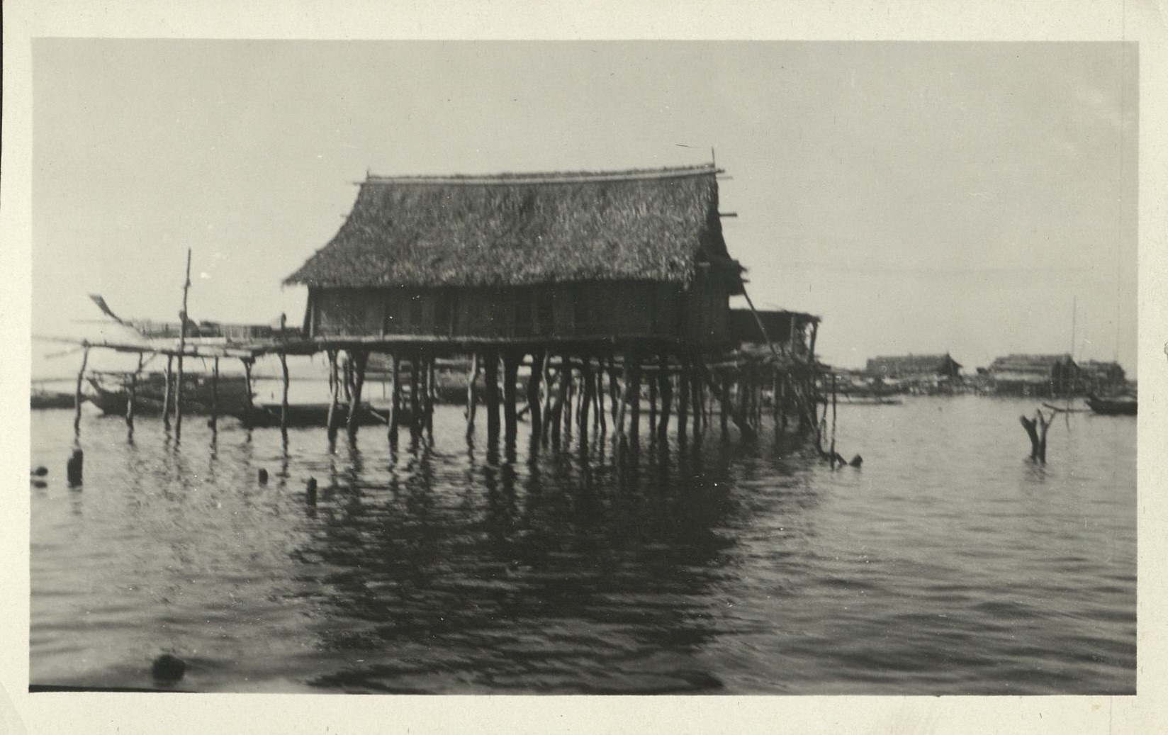 [Untitled – Filipino fishing village, huts elevated over the sea].