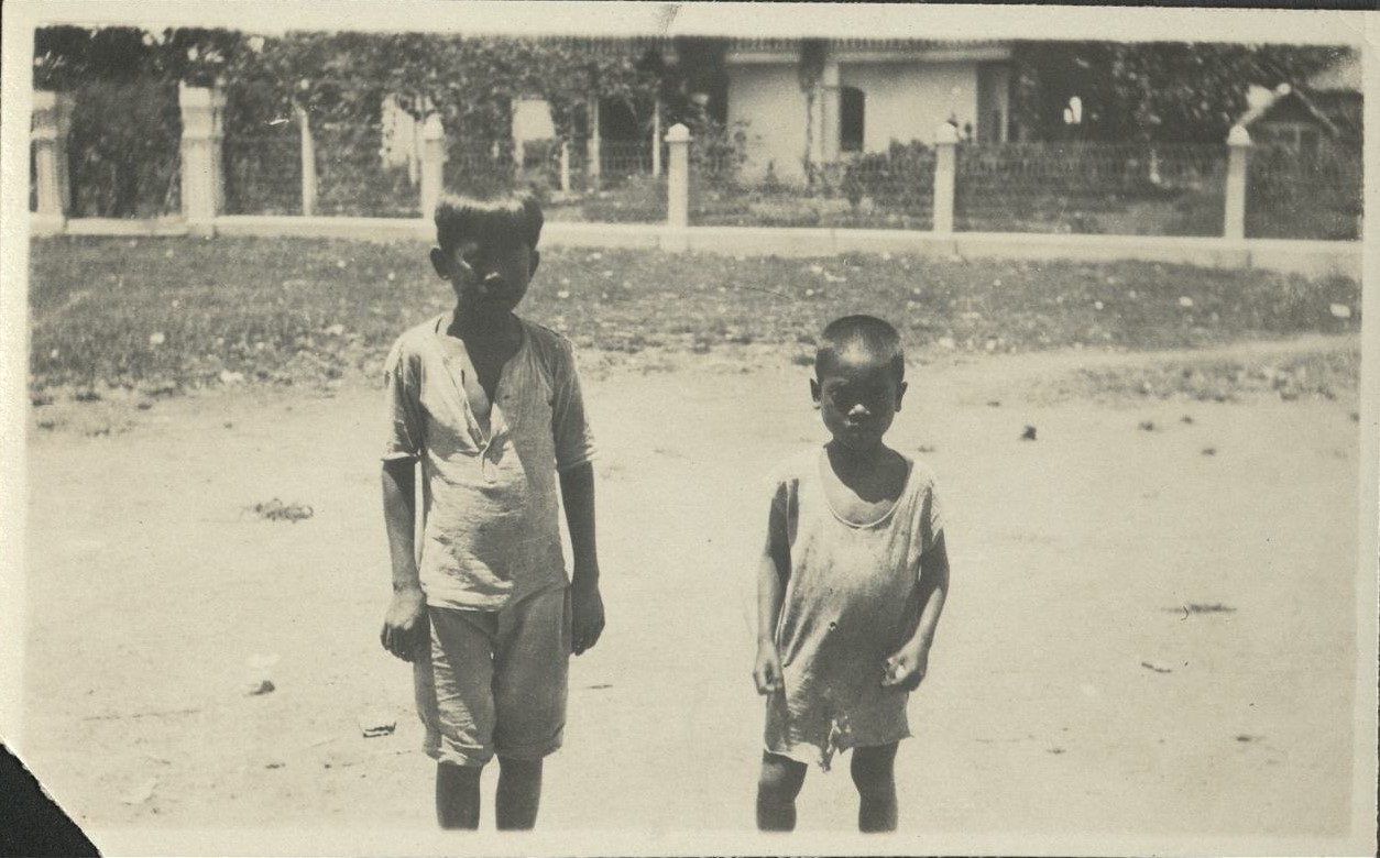 [Untitled – Two boys pose in front of a residence. La Casa Grande, Central San Isidro, Kabankalan, Negros Occidental?].
