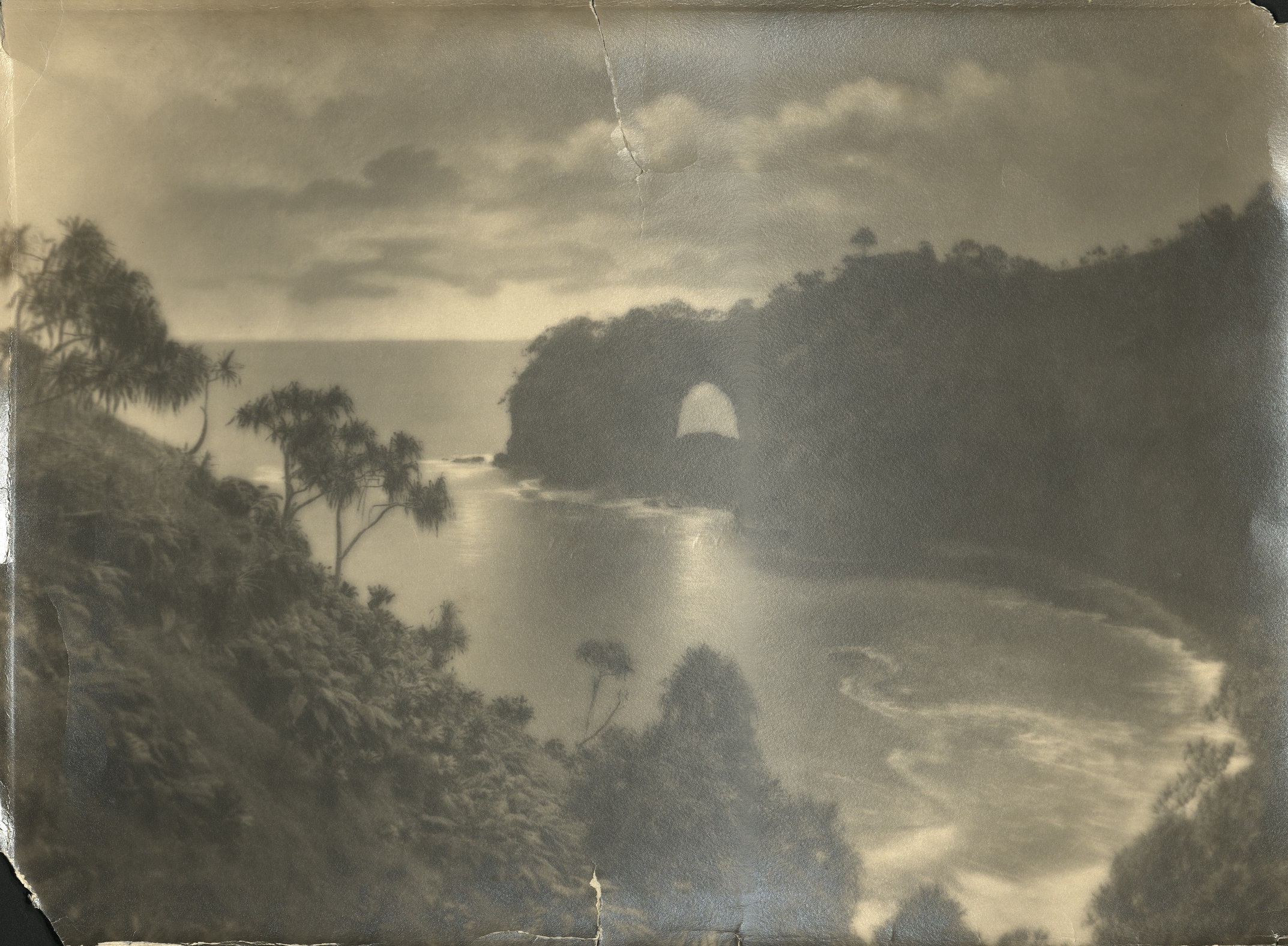 [Untitled – Rocky cape with a natural arch opening and small bay].
