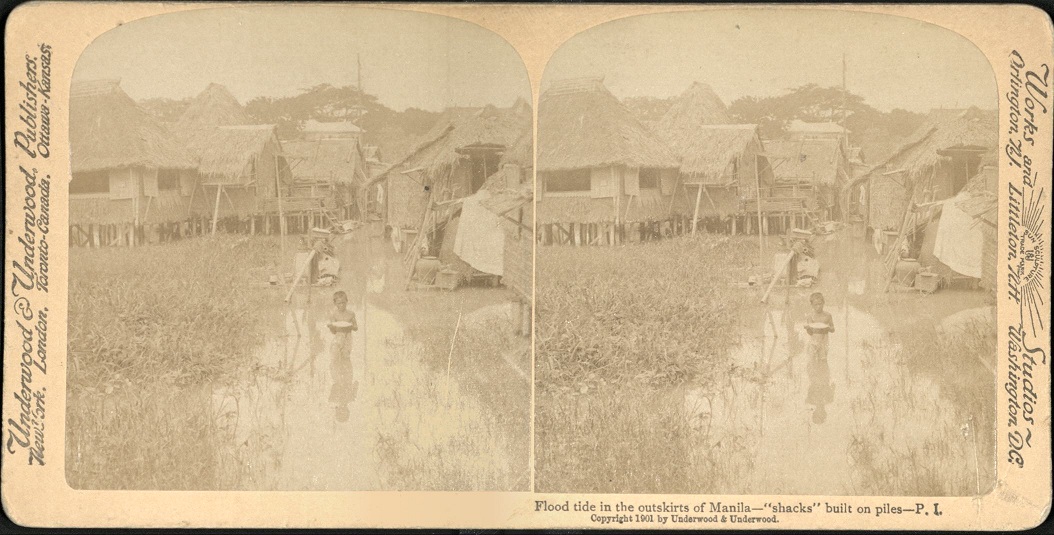 Flood tide in the outskirts of Manila – “shacks” built on piles – P. I.