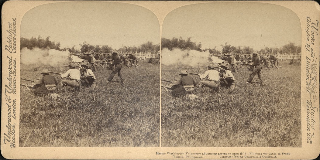 Heroic Washington Volunteers advancing across an open field – Filipinos 800 yards in front – Taquig [Taguig], Philippines.